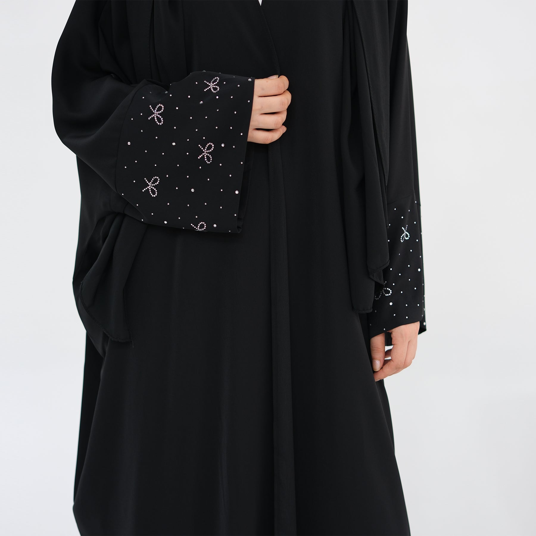 Black abaya with decorative sleeves on a white background. AlLayaliEmbroideredOpenAbaya_Noor_GraceBlack7