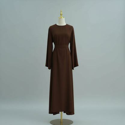 Brown dress on a mannequin against a gray background. AsasAbayaInnerDress_Noor_Grace Coffee - Noor & Grace