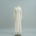 Beige dress on a mannequin against a white paneled wall. AsasAbayaInnerDress_Noor_Grace Beige - Noor & Grae