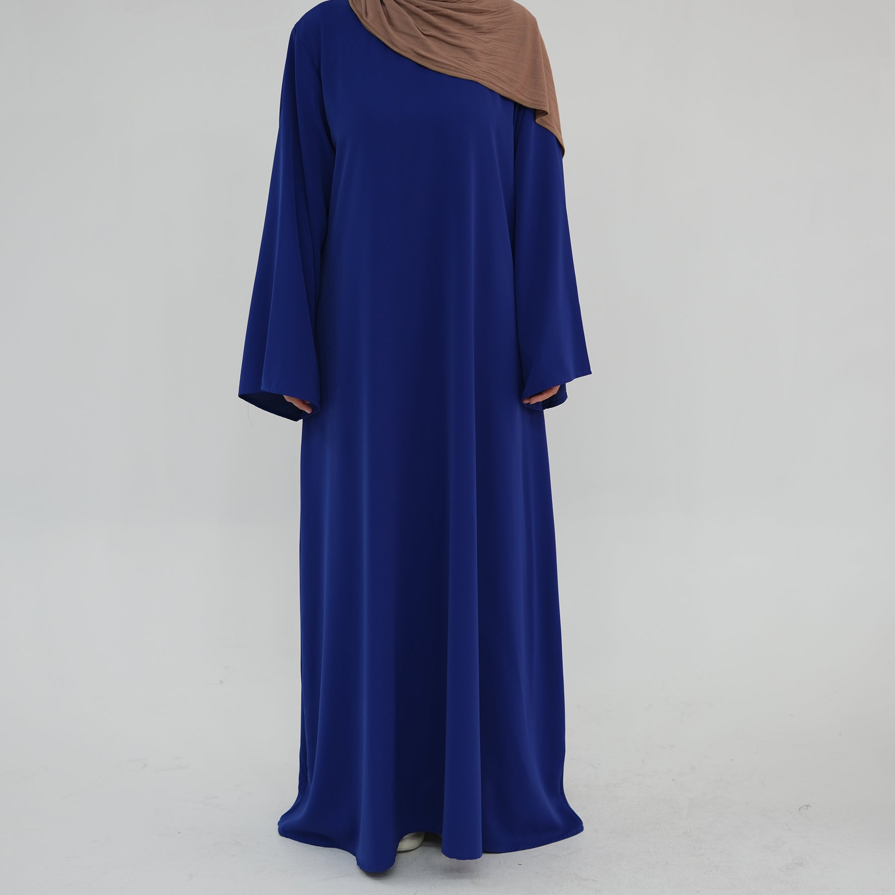 Blue dress with a brown hijab on a white background