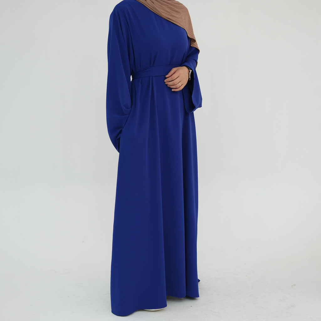 Long blue dress with a plain background