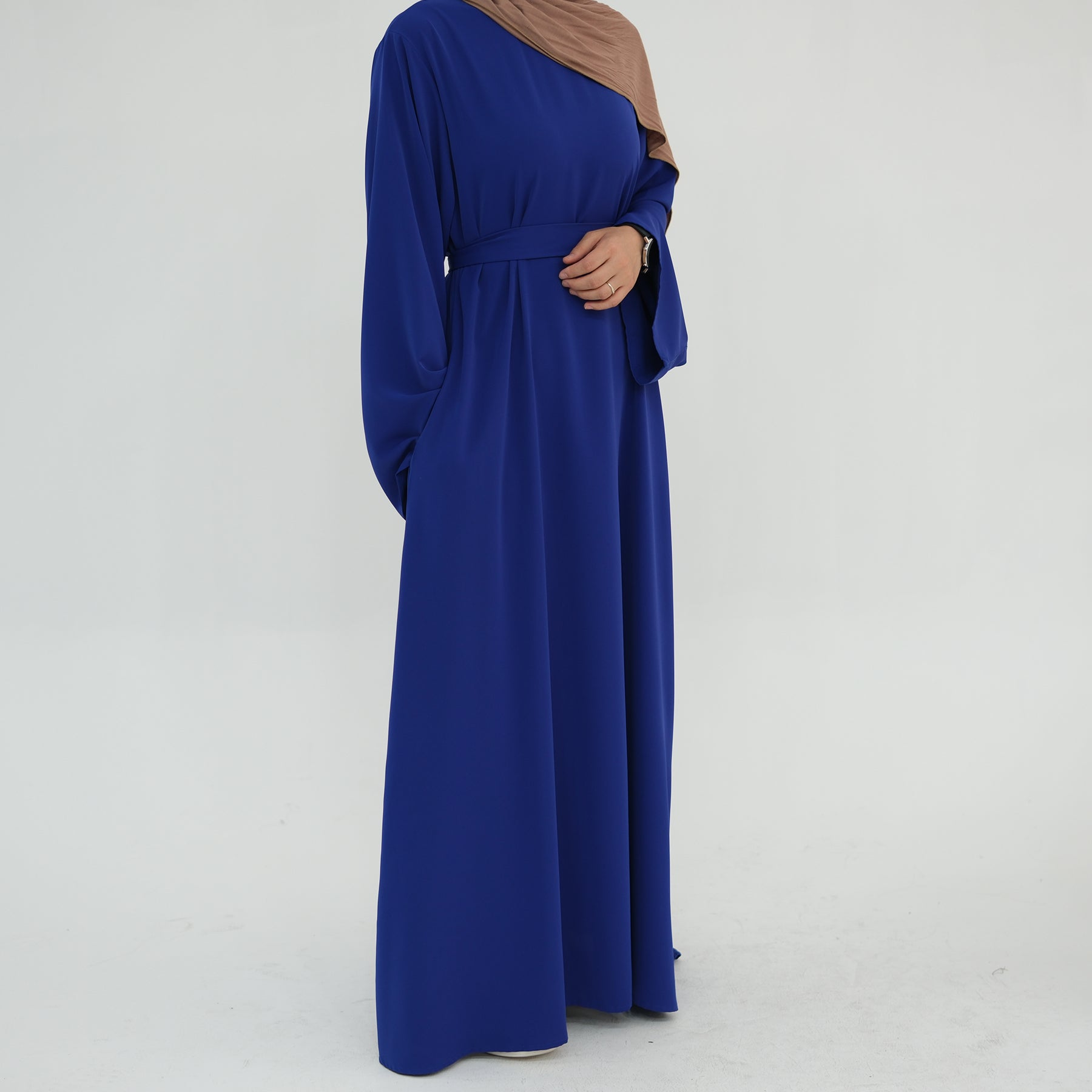 Long blue dress with a plain background