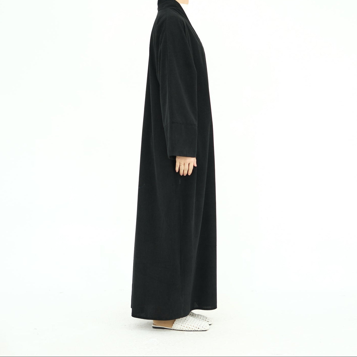Woman wearing a black abaya on a white background. ClassicCorduroyAbaya_Black1 - Noor & Grace