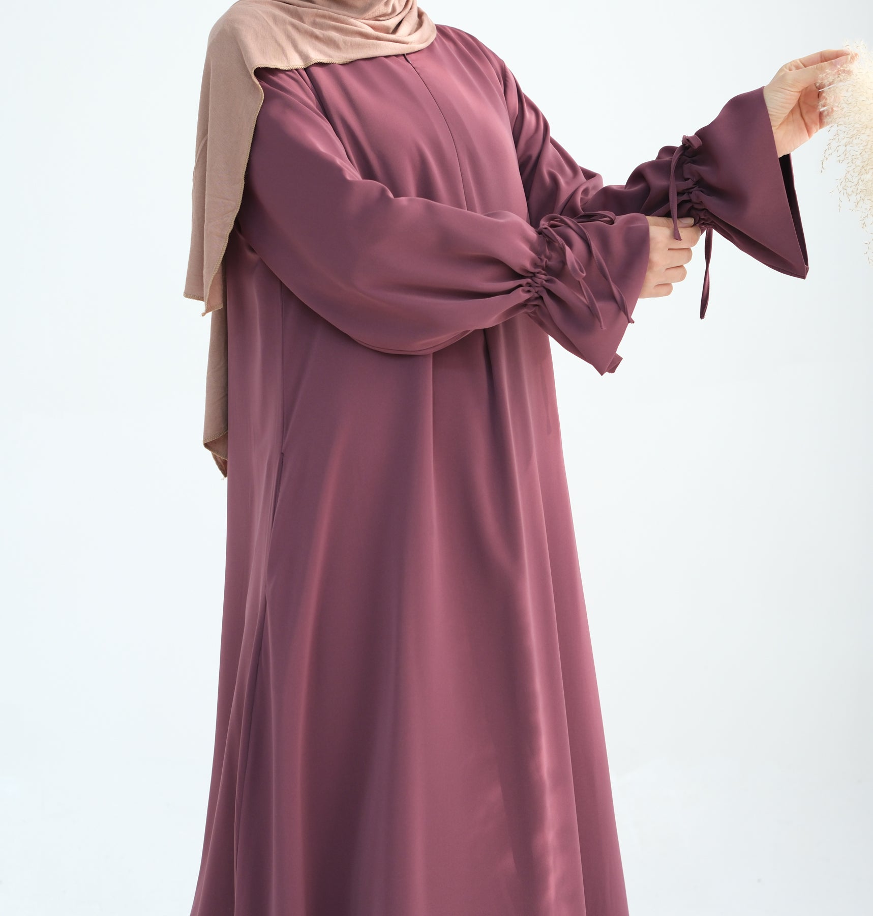Purple dress with long sleeves and a matching headscarf on a white background