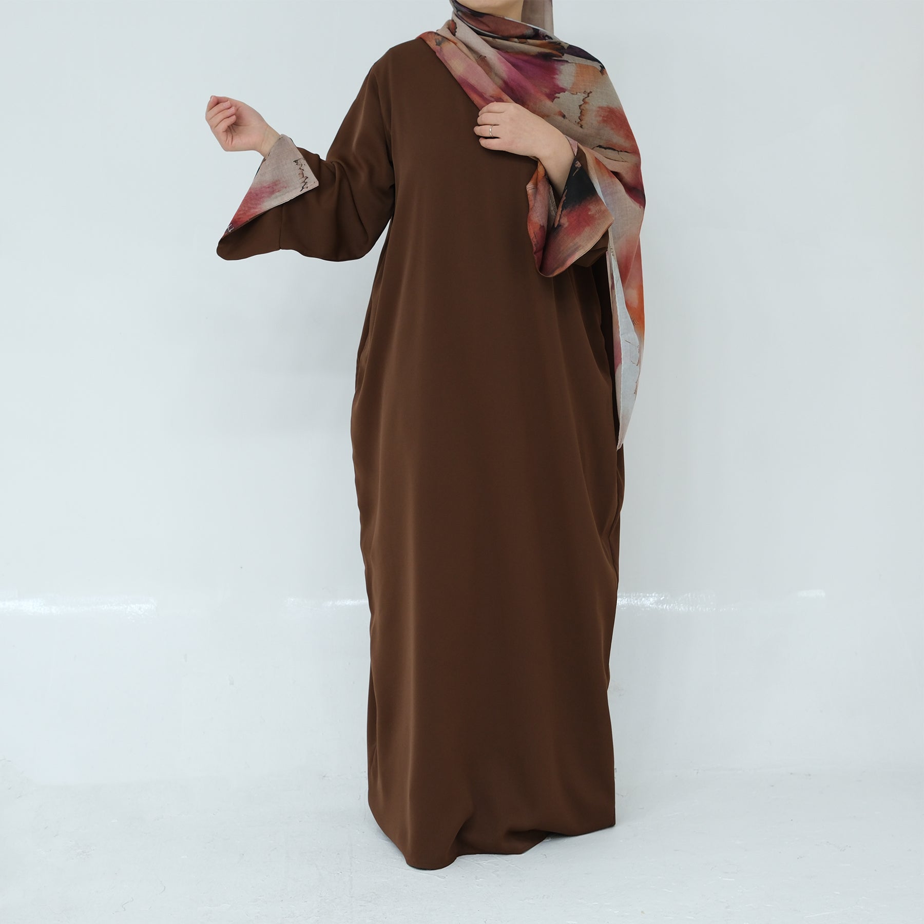 Brown dress with floral hijab on a white background