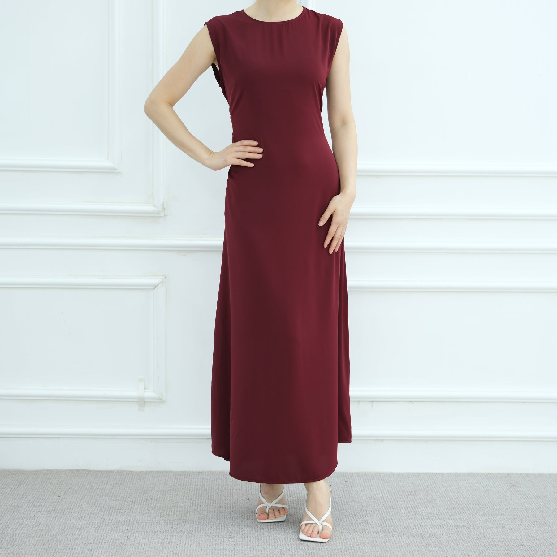Maroon dress worn by a person against a white background