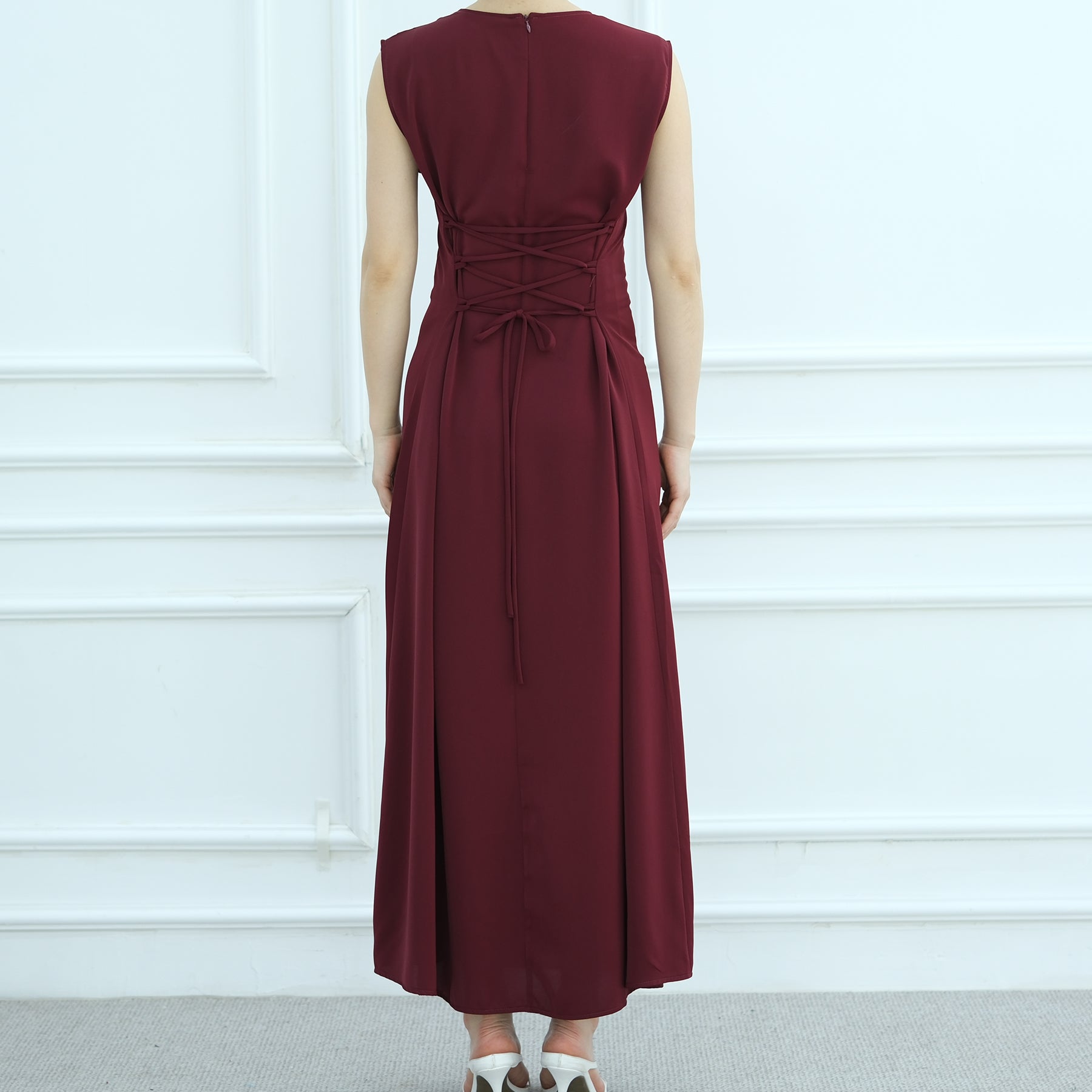 Maroon dress with a tie waist on a white background