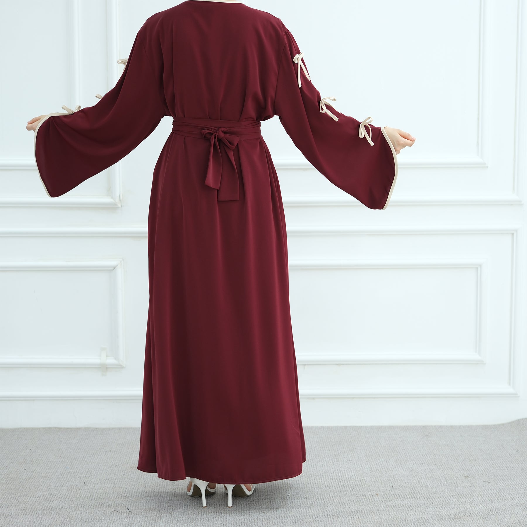 Maroon long-sleeve dress with a belt on a white background