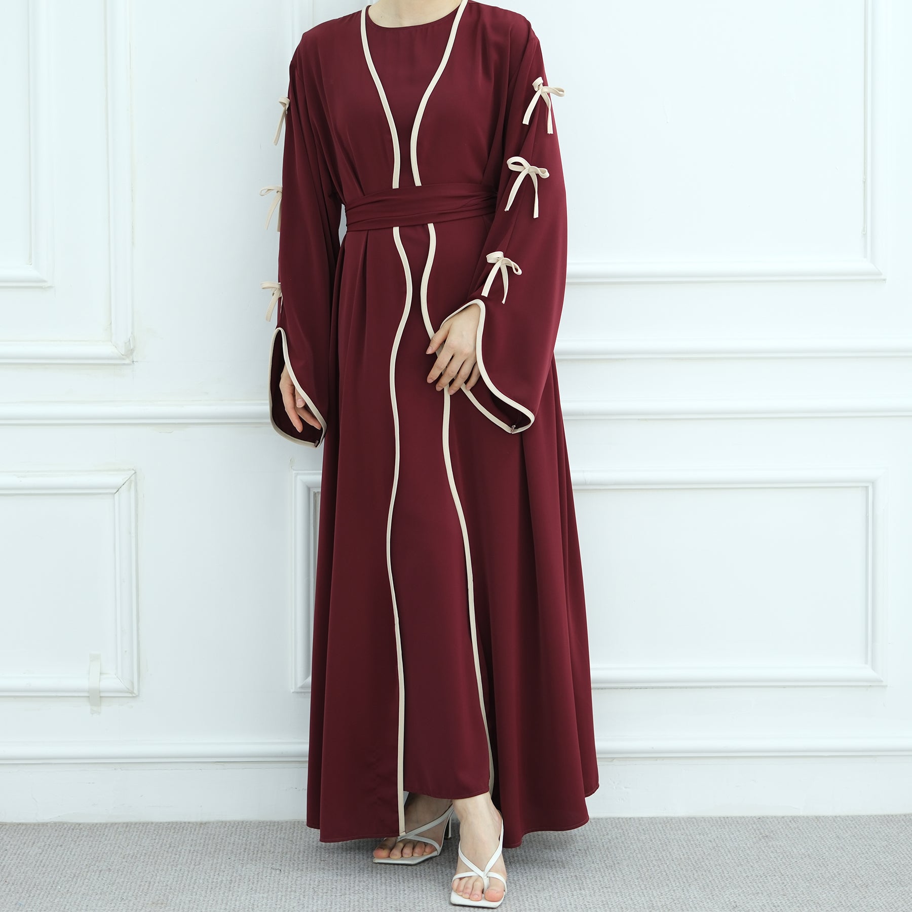 Maroon dress with white trim on a white background