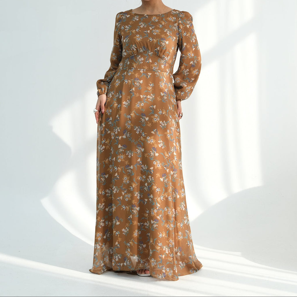 Woman wearing a long brown floral dress on a white background