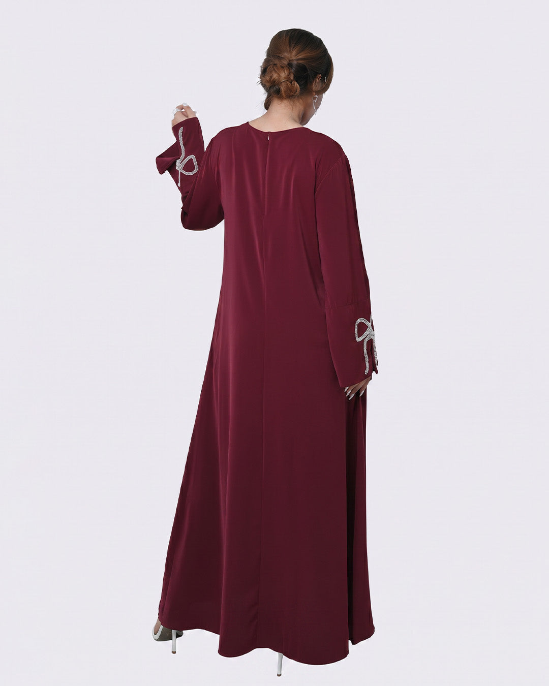 Maroon long-sleeve dress worn by a person on a white background