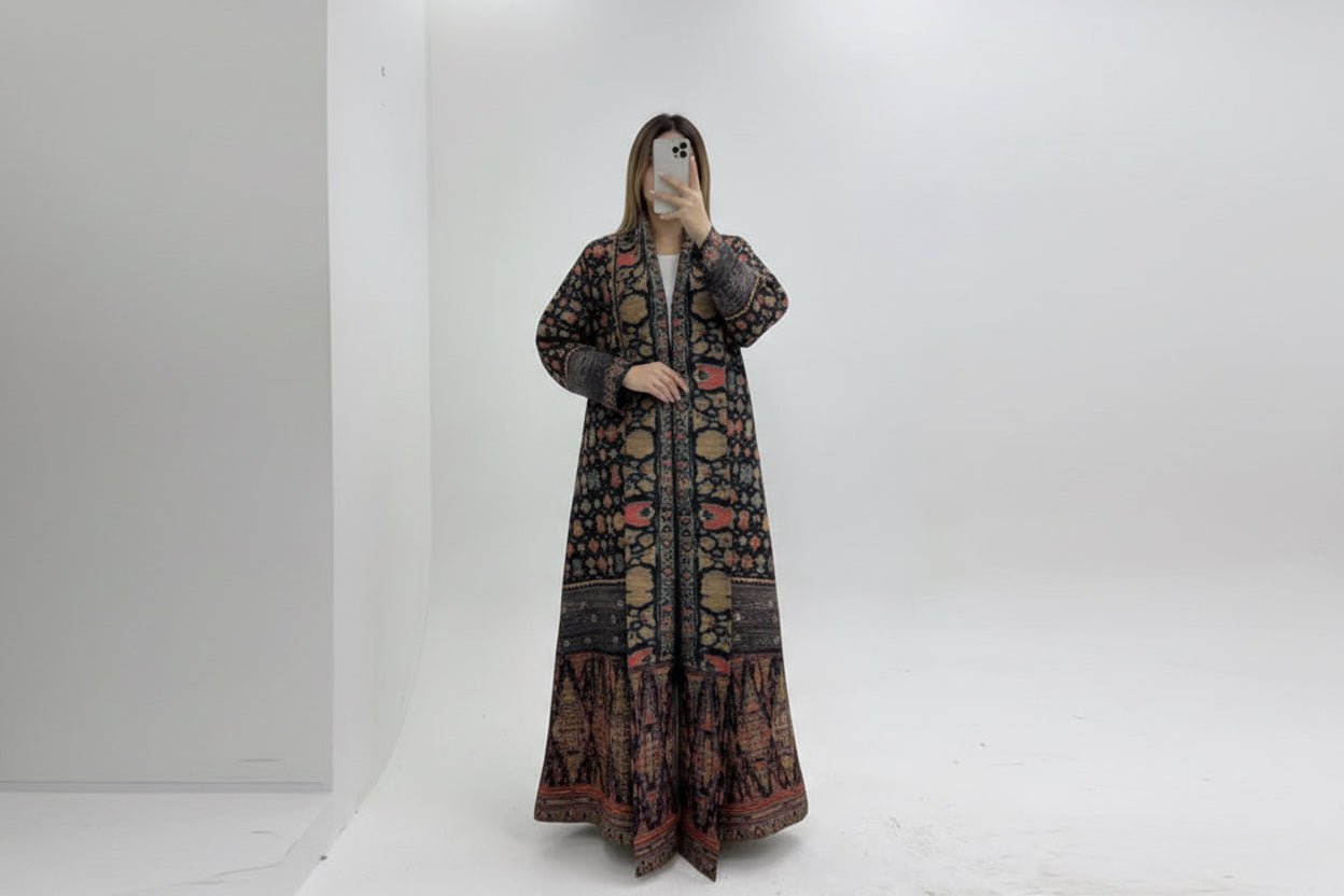 Shop trending stretchable fabric abayas available in many elegant colors. Soft, flexible, and comfortable abayas perfect for everyday wear, work, and travel. Long patterned coat on a mannequin against a white background