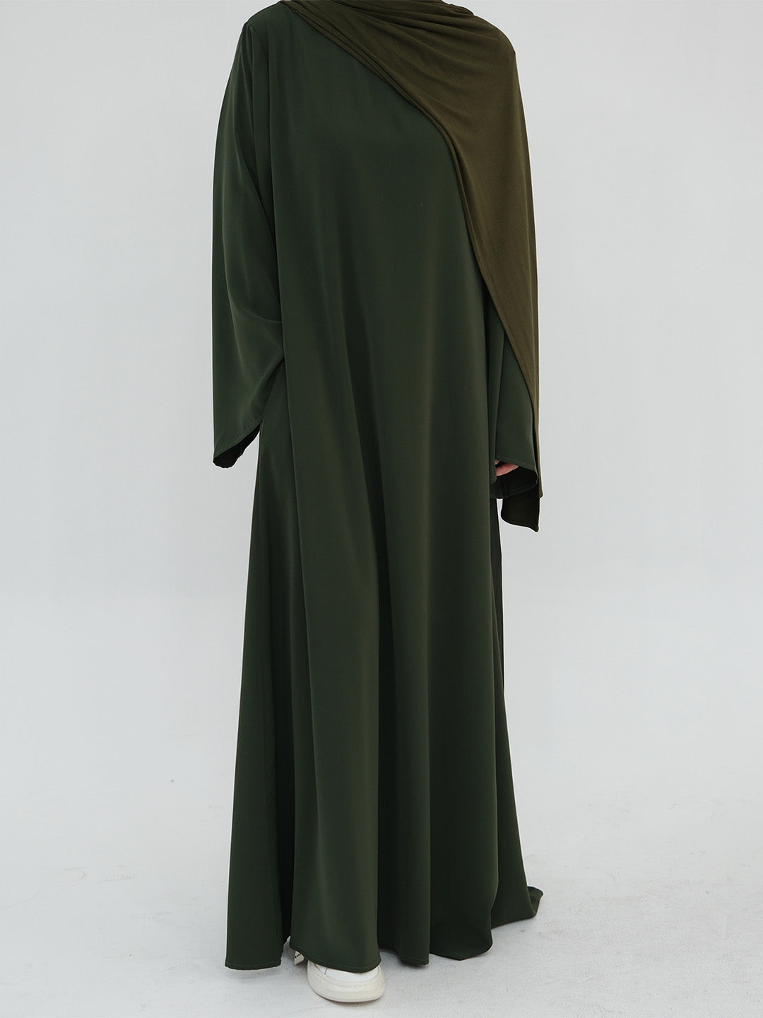 A dark olive green long-sleeved abaya dress with a matching draped hijab, shown from the back on a model against a light gray studio background.