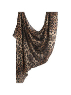 A leopard print scarf draped to show its lightweight, semi-sheer texture against a plain white background.