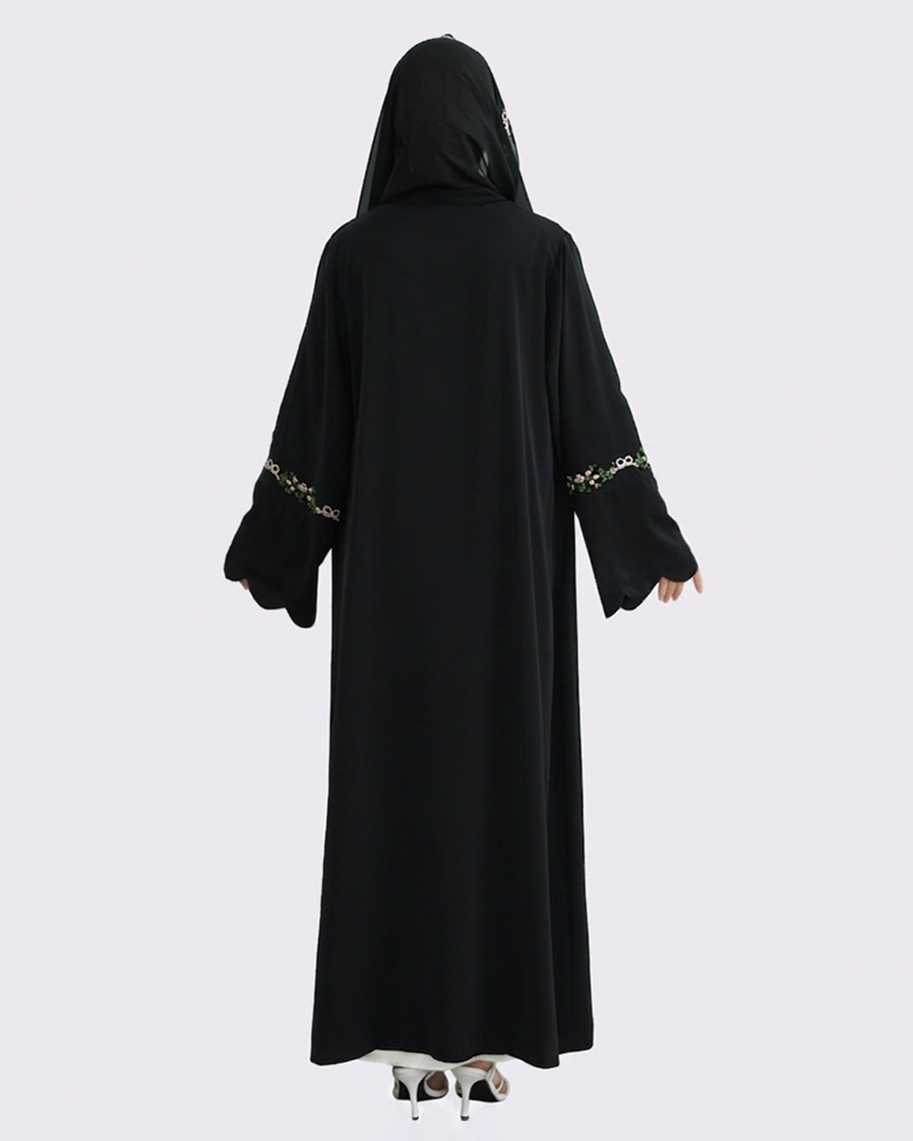 Black abaya with gold embroidery on a white background