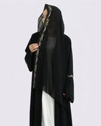 Black abaya with floral embroidery on a white background