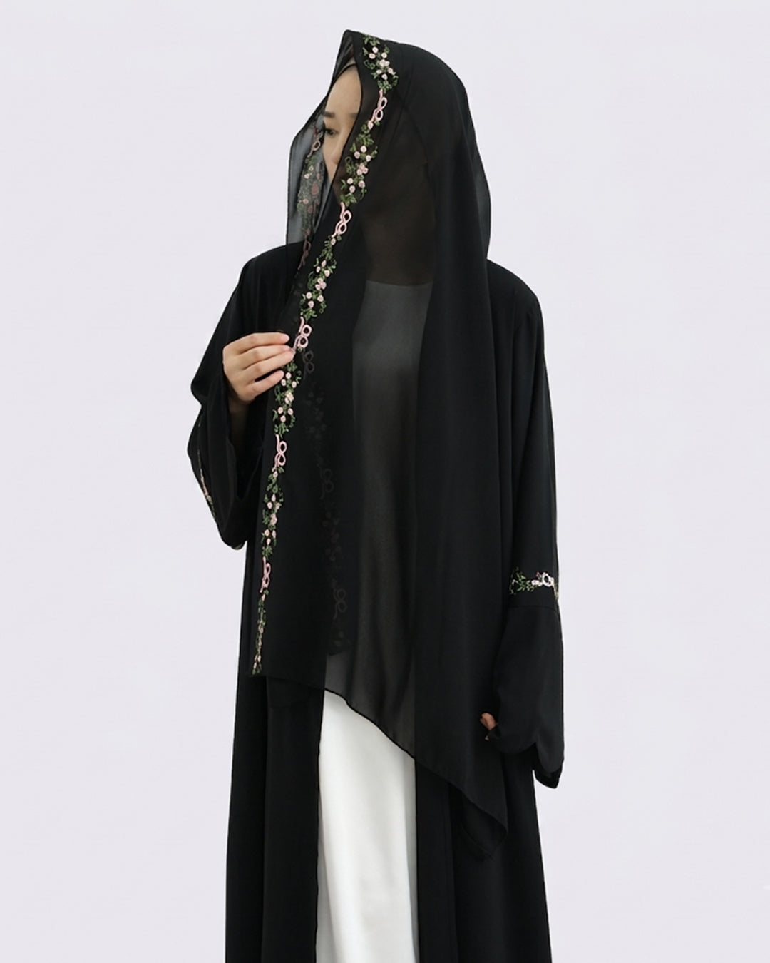 Black abaya with floral embroidery on a white background