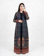 A woman takes a mirror selfie wearing a long navy blue printed kurta with intricate red, gold, and brown patterns, paired with a black top and a black skirt.
