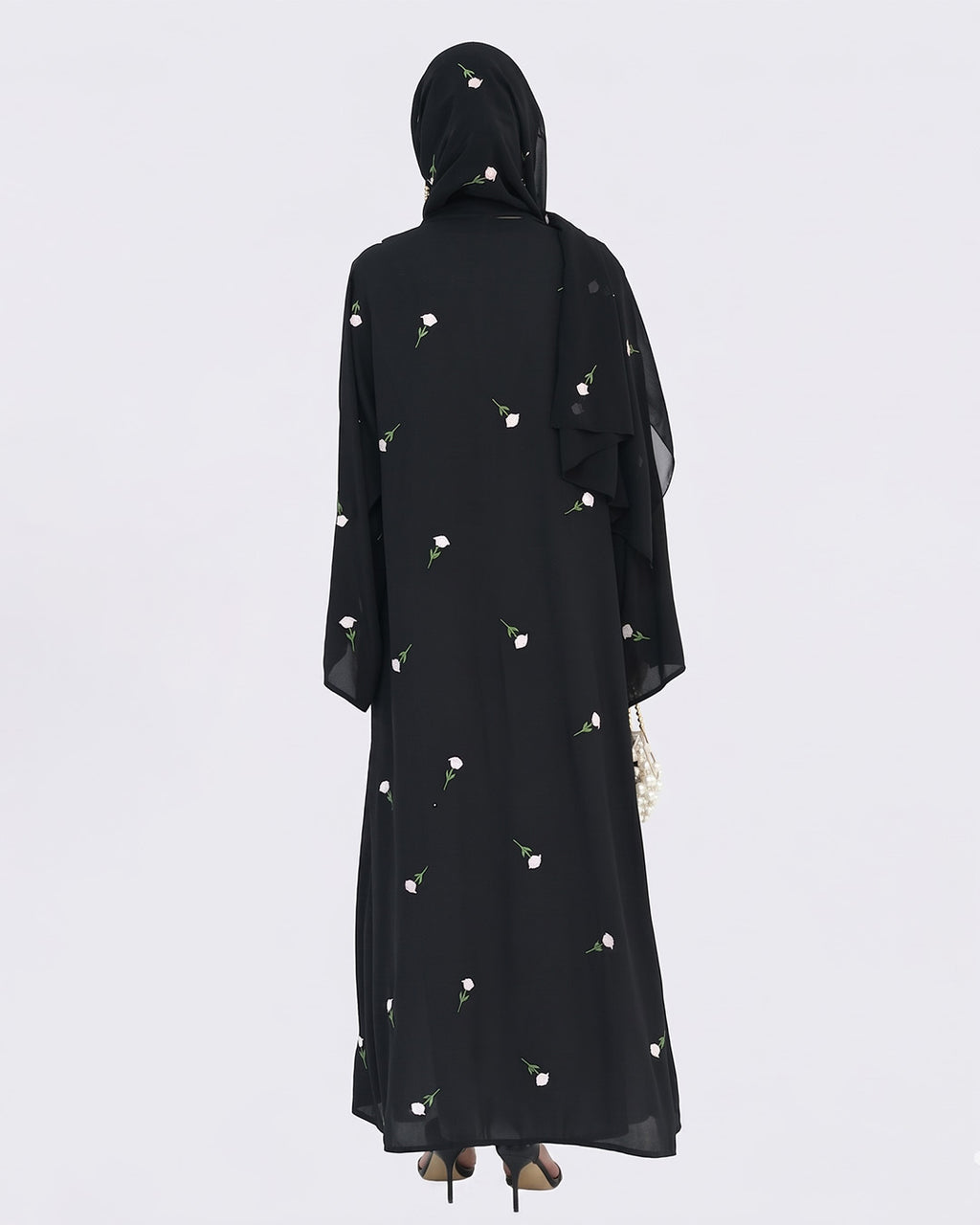 Black abaya with floral patterns on a white background