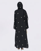 Black abaya with floral patterns on a white background