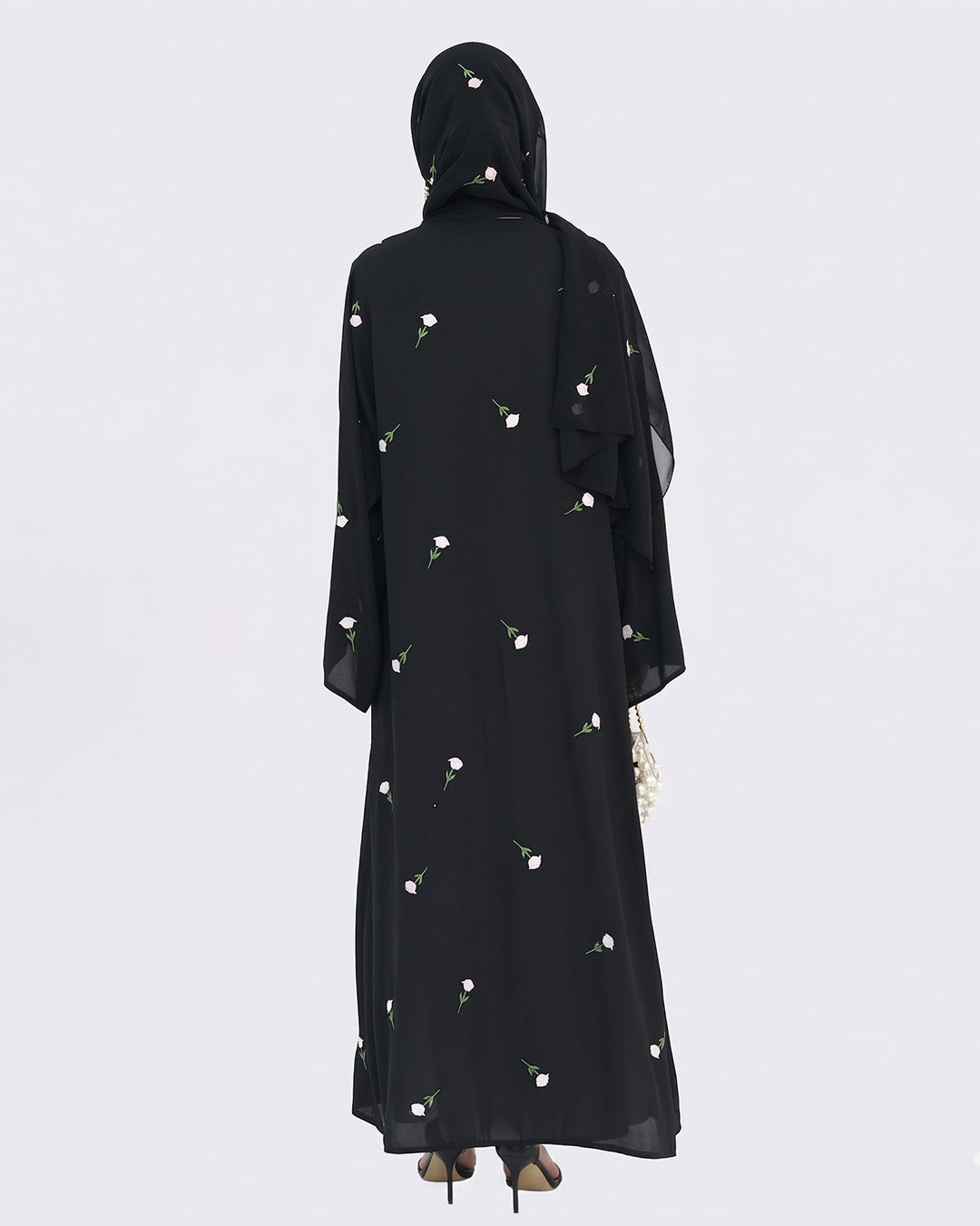 Black abaya with floral patterns on a white background