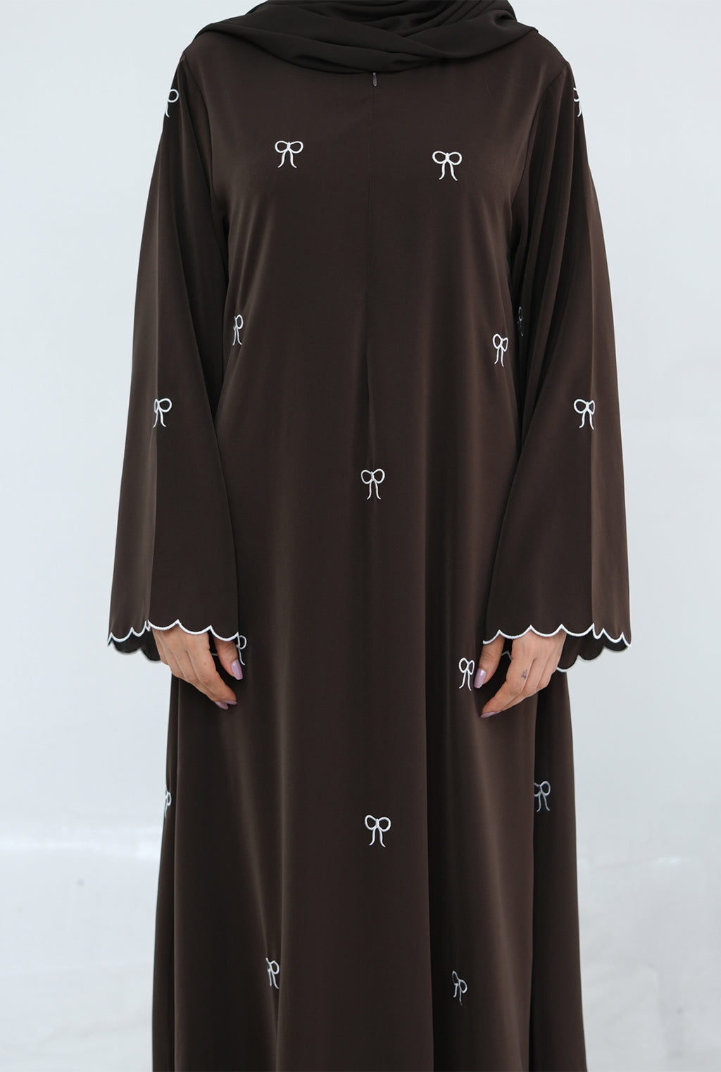 Brown dress with white embroidery on a white background