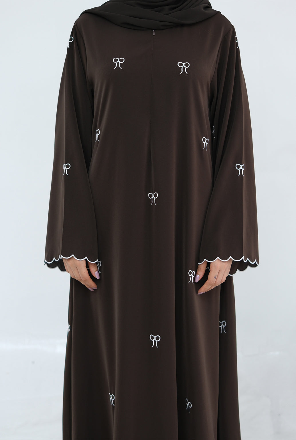 Brown dress with white embroidery on a white background