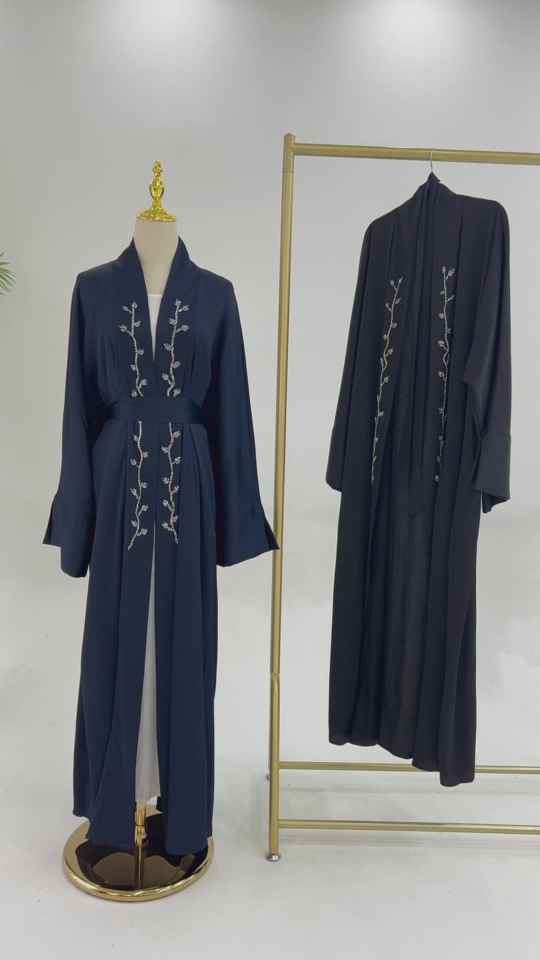 A video of a wrinkle satin abaya with a , displaying the fabric texture and color. Sundus Luxury Abaya (عباية سندس الفاخرة) - Noor & Grace
