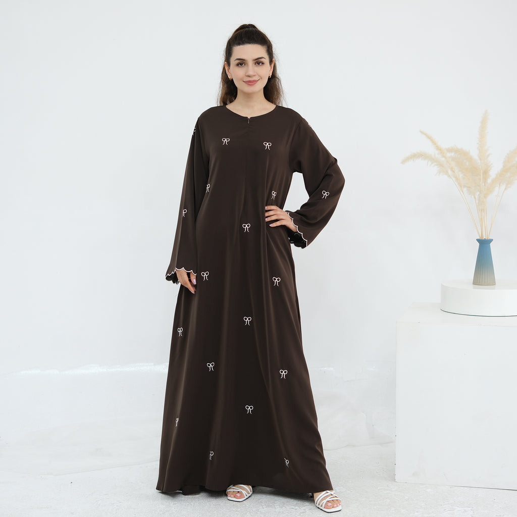 Black abaya with white embroidery on a white background