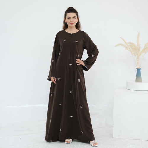 Black abaya with white embroidery on a white background