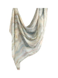 A lightweight draped scarf with a marbled stone pattern in soft beige, gray, and muted blue tones, shown against a plain white background.