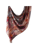 A lightweight, semi-sheer scarf with an abstract marbled pattern in shades of brown, orange, purple, and beige, draped against a solid white background.